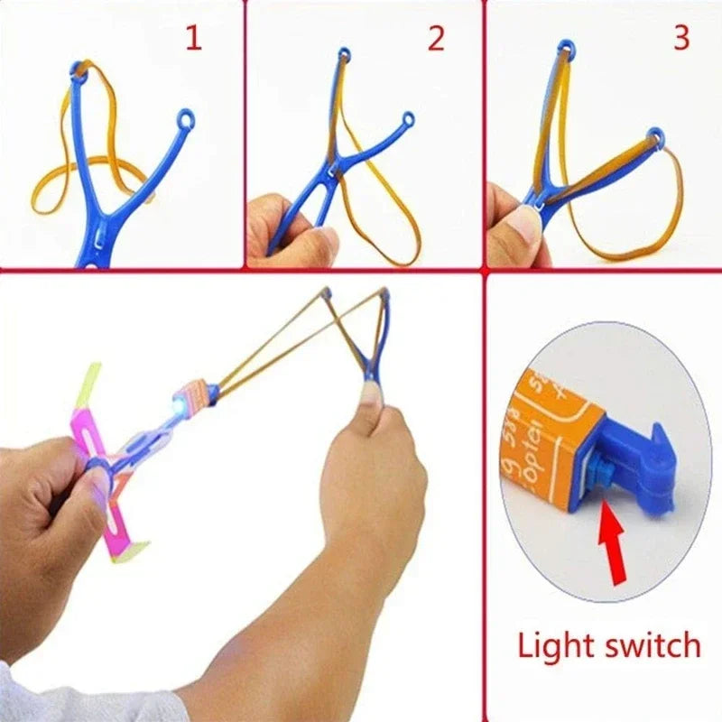 Cohete helicóptero LED con flecha luminosa — Juguete volador con catapulta de goma para niños y adultos